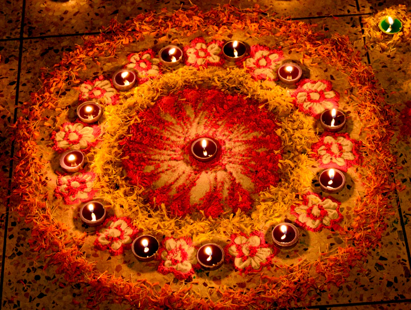 Rangoli with lit diyas