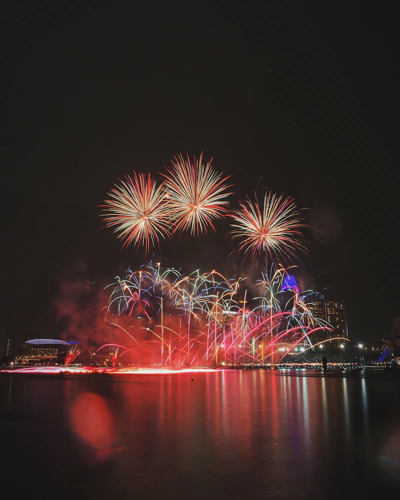 Fireworks reflected over water at night