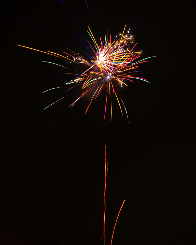 Rocket trail rising to burst in the sky