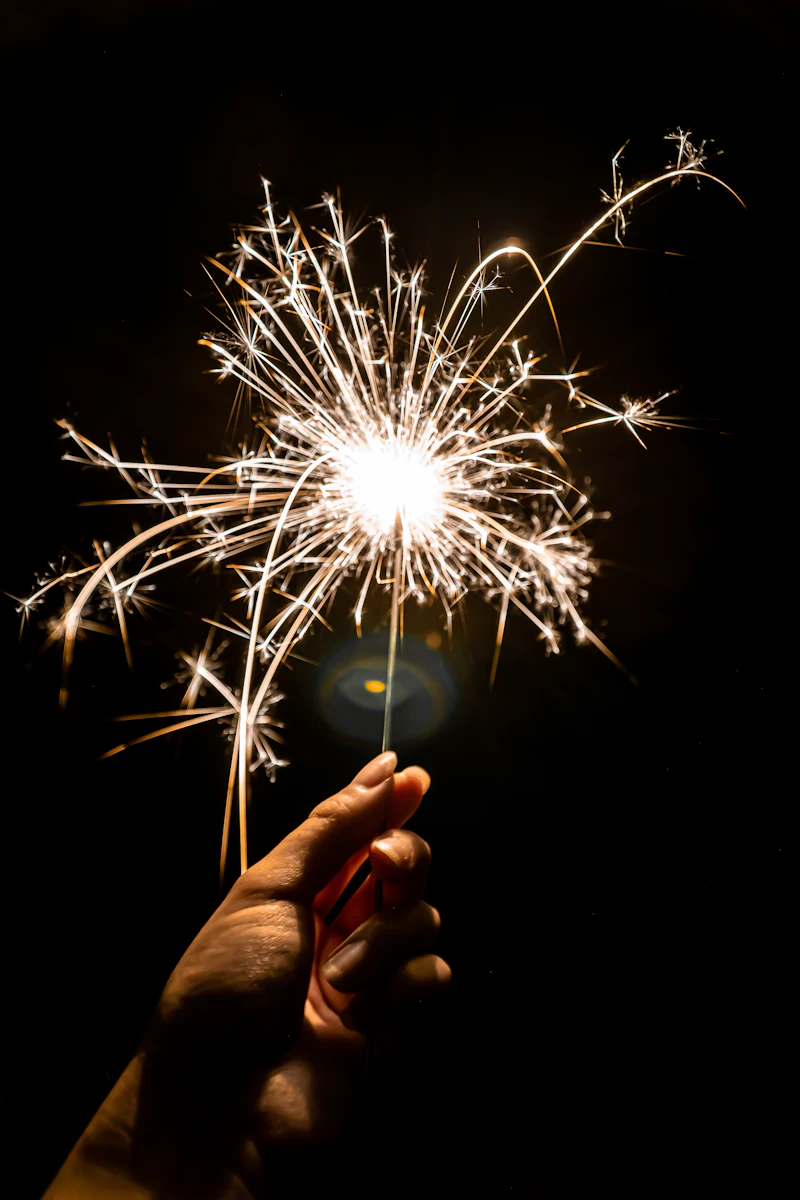 Child holding a sparkler at night